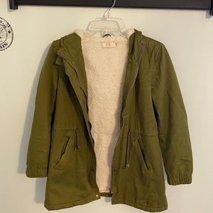 Woman’s green fuzzy jacket